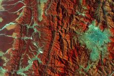 This image captured by the Copernicus Sentinel-2A satellite on 28 December 2015. It demonstrates Nepal’s varied terrain from the mountains to the north (left side) to the plains in the south (right side). Vegetation appears red in this false-colour image, while waterways and buildings appear light green and blue. Image: ESA.