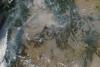 Satellite image of active wildfires across Western U.S., outlined in red (Image: NASA)