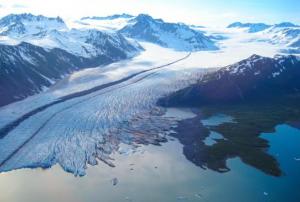 The terminus of Bear Glacier occurs in iceberg filled freshwater lagoon. Kenai Fjords National Park, Alaska. Image: NASA.