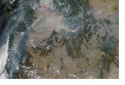 Satellite image of active wildfires across Western U.S., outlined in red (Image: NASA)