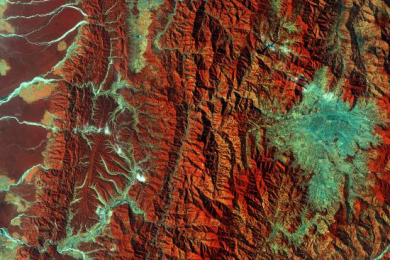 This image captured by the Copernicus Sentinel-2A satellite on 28 December 2015. It demonstrates Nepal’s varied terrain from the mountains to the north (left side) to the plains in the south (right side). Vegetation appears red in this false-colour image, while waterways and buildings appear light green and blue. Image: ESA.